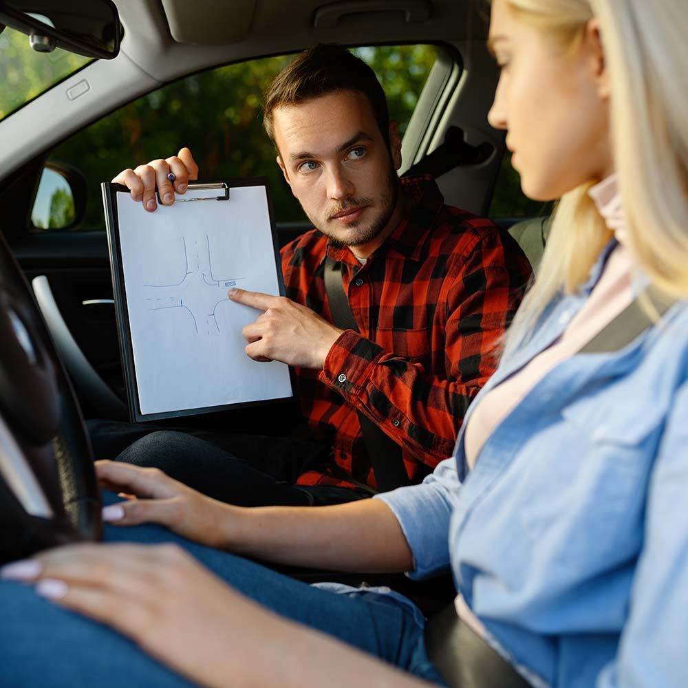 woman-and-man-with-checklist-driving-school-DLAAXGQ.jpg